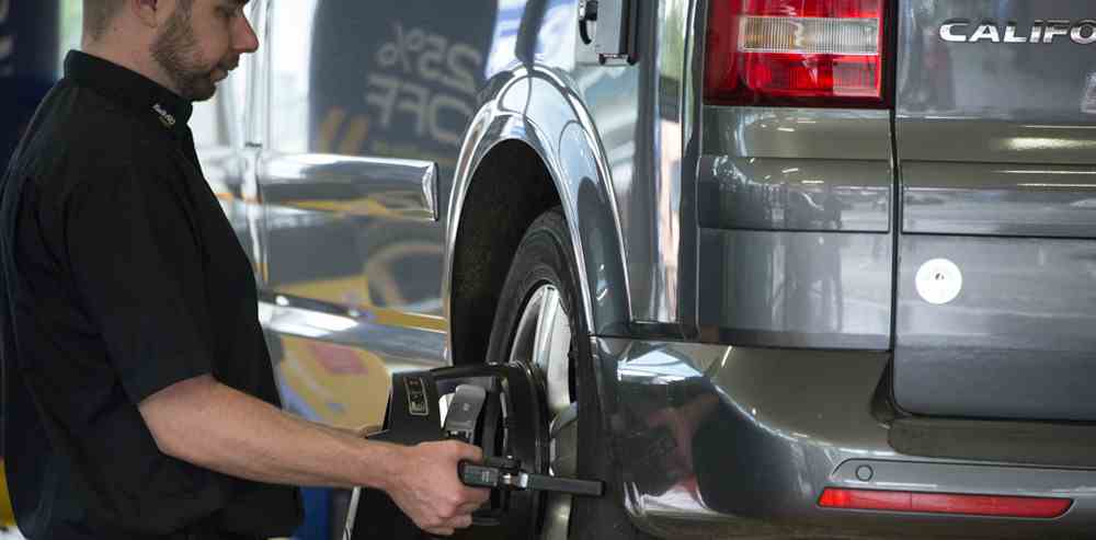 Attaching wheel alignment sensor to vehicle