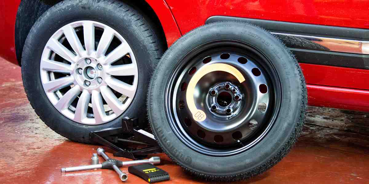 Close up photo of a space saver tyre, with the yellow safety label in focus.