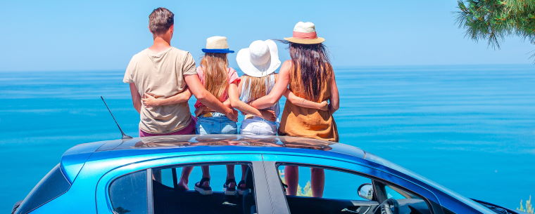 A family of four taking their car out for a staycation