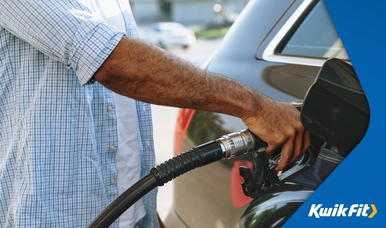 river fills their black family car up with fuel.