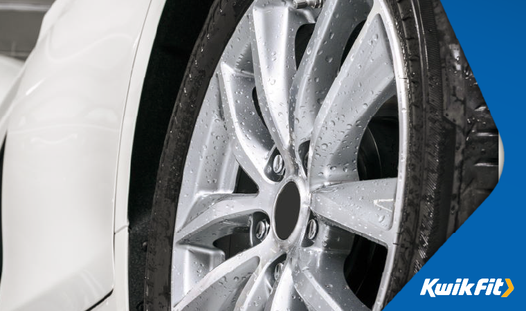 A freshly cleaned tyre on a white car.