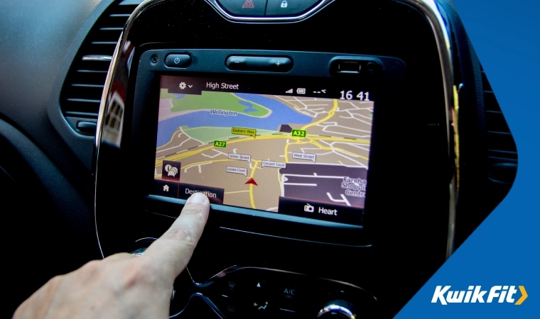 Person pressing the map on a touch screen in a vehicle.