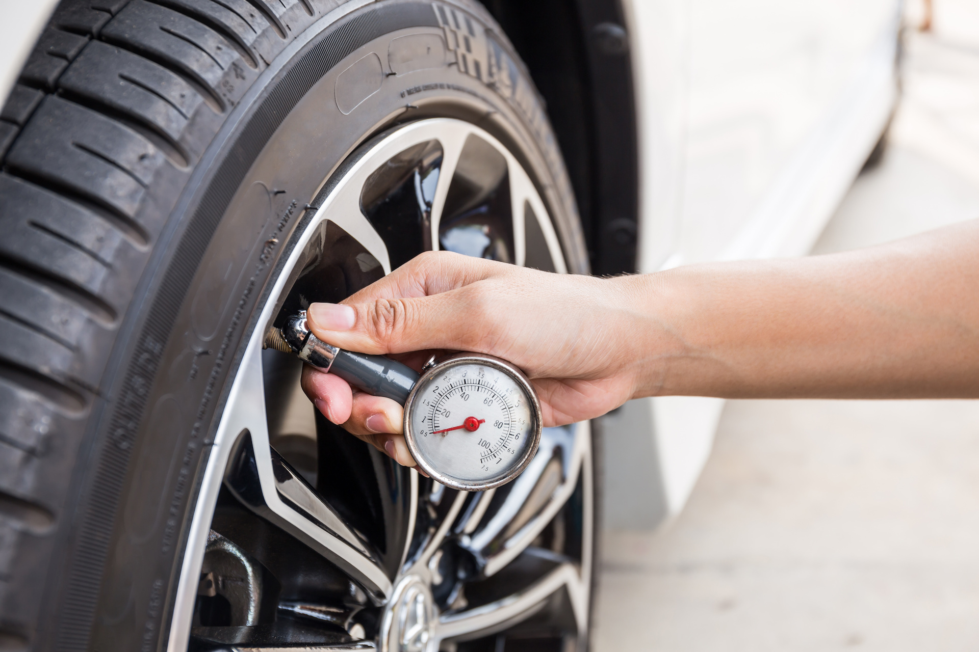 Driver checking their tyre pressure.