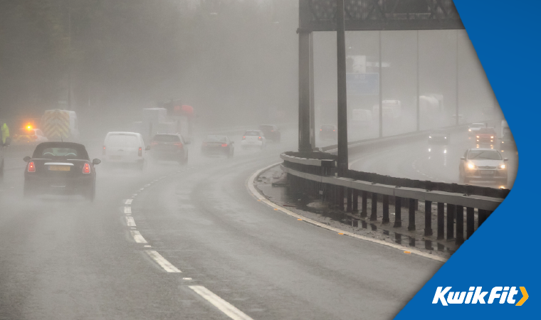 Vehicles driving on a rainy motorway.