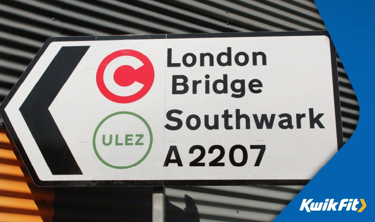 Road sign in London signalling for vehicles to turn left to go London Bridge and Southwark A2207. The sign also has a ULEZ logo on there to warn drivers that they are coming into a ULEZ zone.