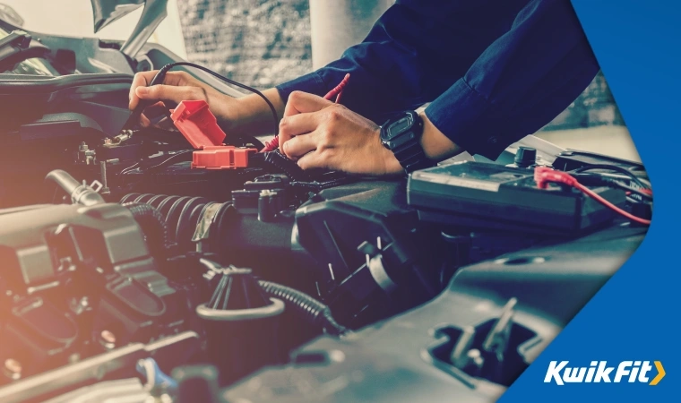 Person checks the voltage of their car battery using a suitable multimeter.