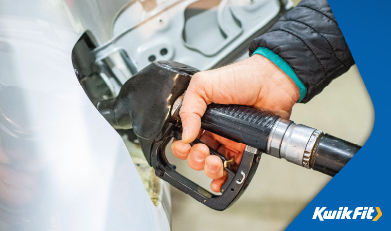 Person filling up a vehicle with petrol.