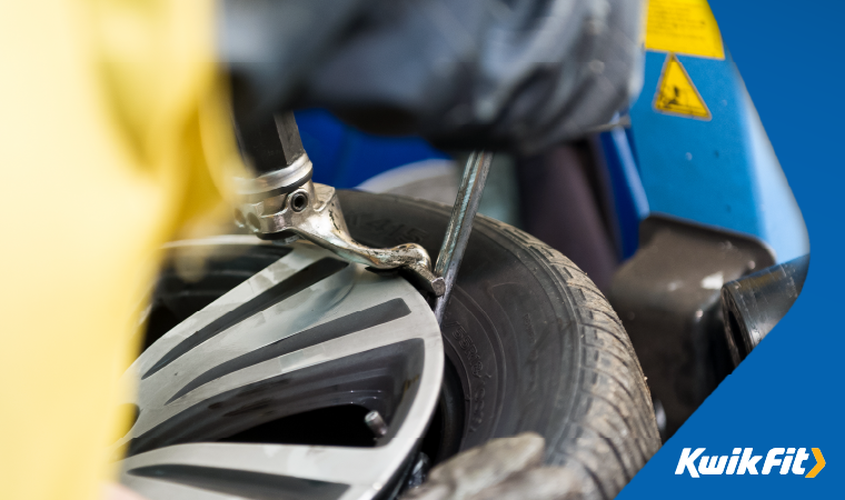 Technician fitting a tyre.